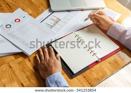 Businessman holding a pen for working on his plan project
