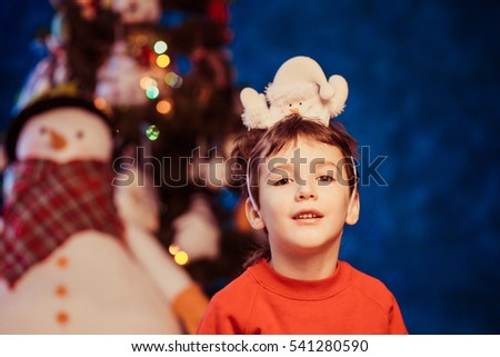 Beautiful boy in Christmas hat in studio