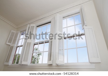 Sky seen through windows with louver shutters Royalty-Free Stock Photo #54128314