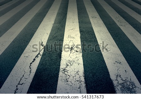 Zebra crossing painted on the asphalt, detail of a signal circulation, traffic information for pedestrians and drivers, security