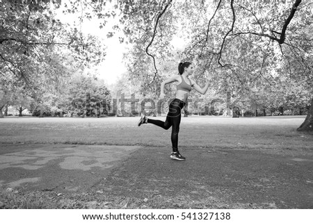 Full length side view of fit woman jogging in park