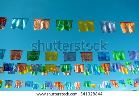 Traditional mexican paper bunting decoration celebratory flags against blue sky