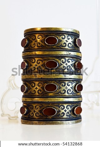 Middle-Asian vintage traditional female bangle. Silver, gilding, semi-precious stones, east ornament. Isolated on white.