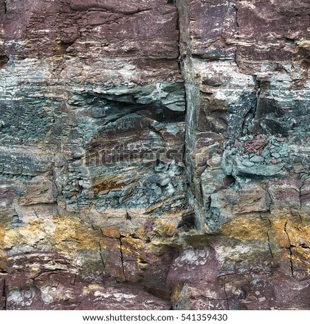 Seamless abstract background. Cracks and colorful layers in natural sandstone as a background. The pattern of the variegated sandstone Geological layers of earth. Sedimentary stone texture closeup