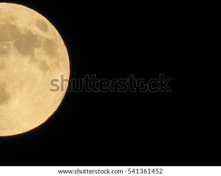 Yellow full moon on the dark night, close up, crop