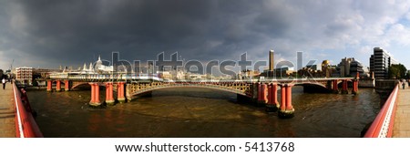 Panoramic view of London skyline and the river Thames with storm clouds brooding