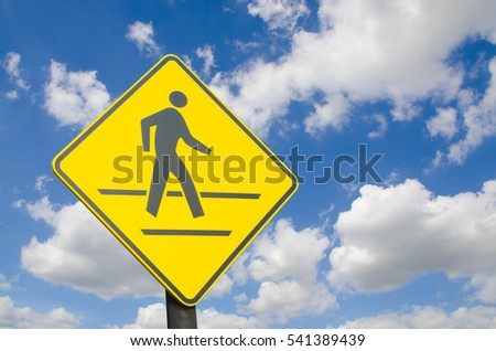 Crossing Signs Traffic yellow board blue sky with cloud background copy space concept of road safety to reduce accidents.
