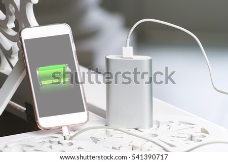 Smartphone and powerbank. s a symbol of mobile energy and electric equipment in modern design