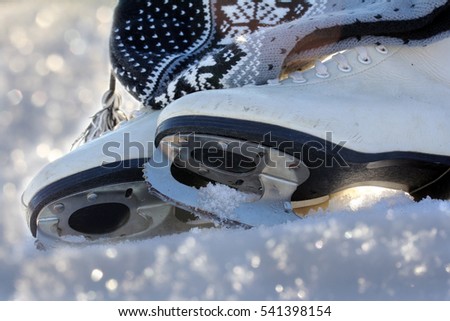 Ice skating is a popular winter sports. Ice skates in the snow