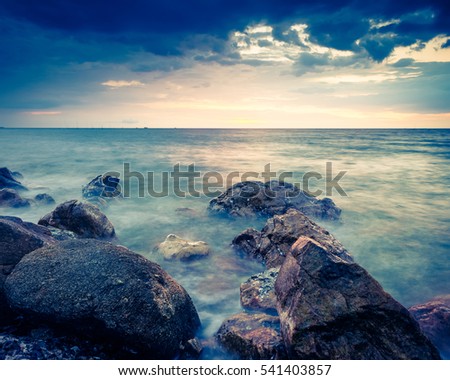 Landscape photo of rocks in the sea in sunset - retro vintage filter effect