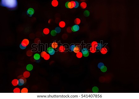 Light of a candle and lamps of different color background