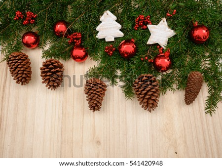 Fir tree with christmas decorations on the wooden background