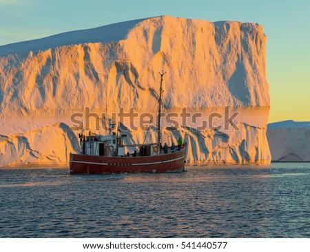 Tourists take pictures of the iceberg. Source of icebergs is by the Jakobshavn glacier. This is a consequence of the phenomenon of global warming and catastrophic thawing of ice, Disko Bay, Greenland 