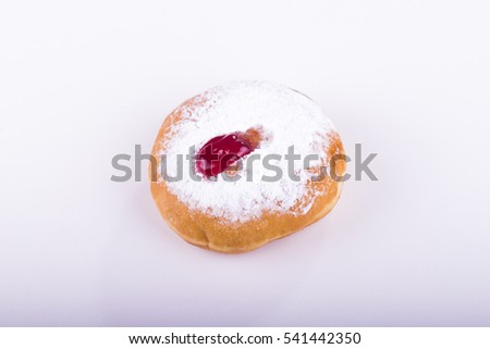 Image of jewish holiday Hanukka with one jelly doughnut (top view) on white background