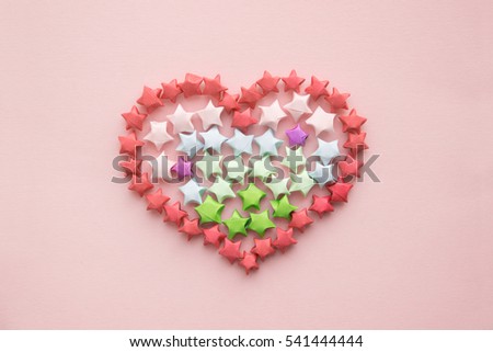 Heart made from small paper colored stars Origami. Valentine's Day.  A close-up. Love Background for design. Flat Lay.