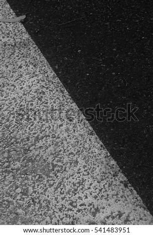 A black and grey cement textured background.