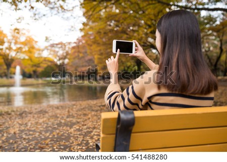 Young woman take photo of cellphone