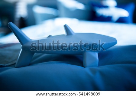 Contemporary home with white shark on blue background
