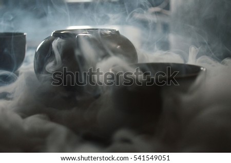 cap of tea in the smoke Royalty-Free Stock Photo #541549051