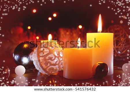 Burning candles flame light at night with bokeh lights on dark background. Christmas candle and decoration background