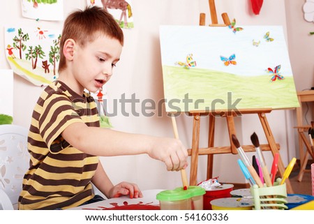 Child paint picture in preschool. Child care.