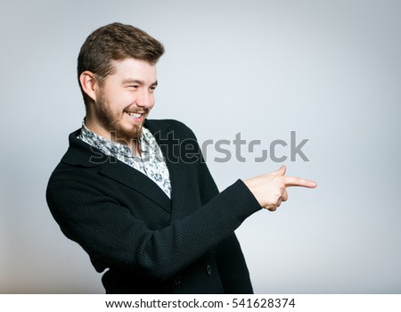 successful young businessman mocking and points his finger, stylish, manager closeup