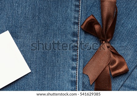 Blue Jeans texture with brown ribbon and white empty tag label