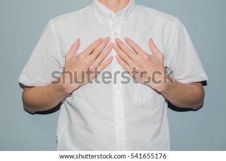 Asian man showing his heartfelt gratitude and thanks clasping his hands to his heart