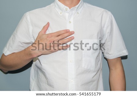 Asian man showing his heartfelt gratitude and thanks clasping his hands to his heart