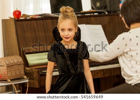 Beautiful little girl in costume and make-up Gothic fashion culture concert Children's Christmas New Year. Emotional colorful children's show in the elementary school