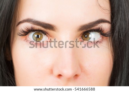 "female eyes with strabismus of pretty woman or cute girl at optician with mad Royalty-Free Stock Photo #541666588