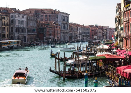 
A view of the city of venice showing one of its most well-known canals full of people and restaurants. Photo taken in October 2016