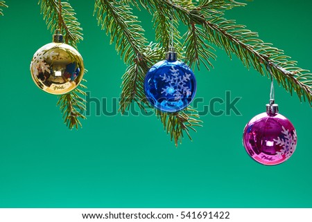 Christmas decorations on the pine branch on colored background
