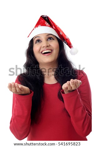 woman in Santa hat with open palms