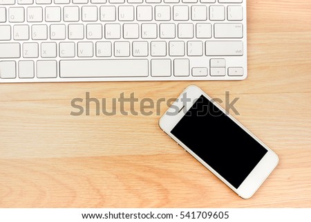 Business working smart phone laptop on wooden table background, top view