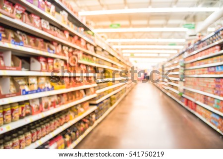 Blurred selection of pasta, ketchup, condiment, tomato sauce and canned vegetable on shelves in store at Humble, Texas, US. Aisle, row variety products, defocused background, bokeh light supermarket. Royalty-Free Stock Photo #541750219