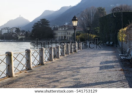 promenade of Lake Como with views of the mountains in the setting winter sun