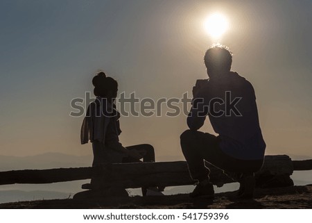 Silhouette of man and woman taking photos on the mountains. Filter effect style