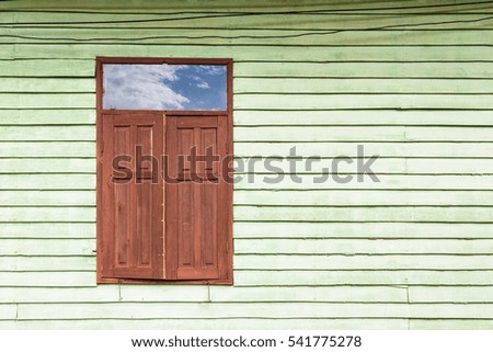 Wooden old house painted with brow window