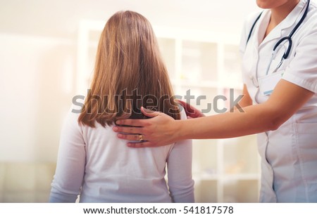 Chiropractor doing adjustment on female patient Royalty-Free Stock Photo #541817578