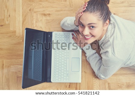 woman lying on floor and using laptop