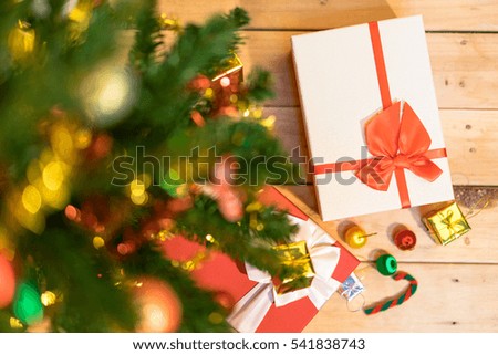 Beautiful Decorated Christmas tree with gifts on wood background. soft focus 
