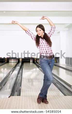 The young girl rejoices to a successful throw in bowling