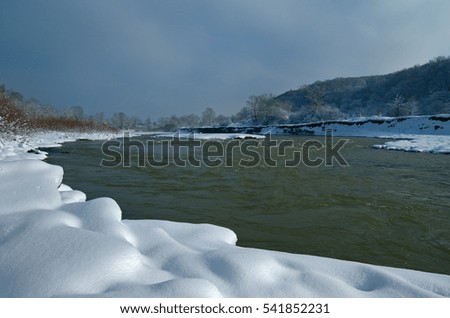 The mountain river in the winter daytime. Beautiful view. Caucasus, Russia