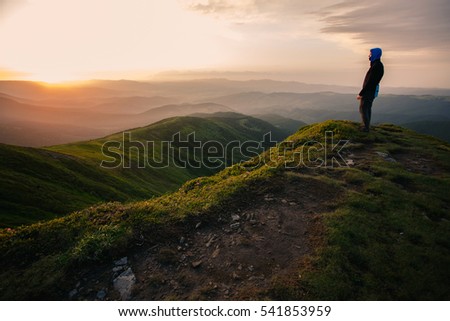 Man on the cliff.
A guy looks on landscape of mountains in the Carpathians. Royalty-Free Stock Photo #541853959