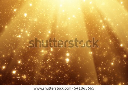Golden rays and sparkles or glitter lights. Merry Christmas festive background.defocused circle bokeh or particles Royalty-Free Stock Photo #541865665