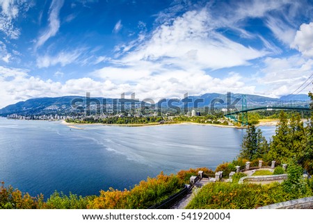 Vancouver skyline panorama taken at Prospect Point in Stanley Park with Lions Gate Bridge on right and West Vancouver on left. It's located on the south side of the First Narrows of Burrard Inlet. Royalty-Free Stock Photo #541920004