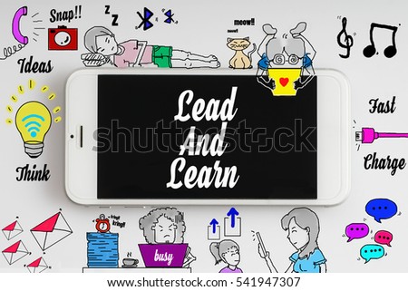 "Lead and learn" words on smartphone with doodle and social media icon - internet, social, marketing and business concept