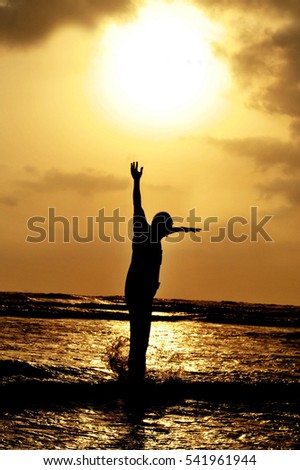 SIlhouette of a man jumping against setting sun on karacchi beach, clifton Pakistan