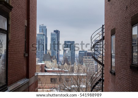 View of Montreal Skyline (Quebec, Canada) in winter from a residential district made of brick buildings
